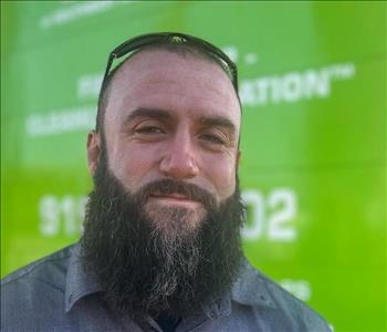 Man standing in front of a green SERVPRO background.